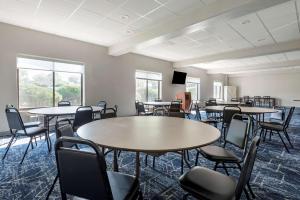 a room with tables and chairs and windows at Comfort Inn Philadelphia International Airport West in Chester