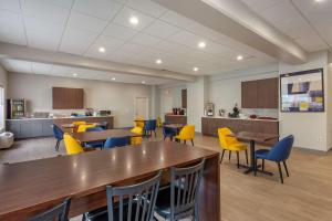 une grande chambre avec des tables et des chaises ainsi qu'une cuisine dans l'établissement Comfort Inn Philadelphia International Airport West, à Chester