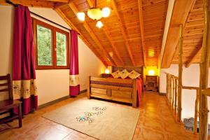a bedroom with a bed and a wooden ceiling at Casa Cachalote - Ferienhaus auf den Azoren in São Caetano