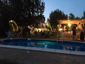 a group of people standing around a pool at night at Il Giardino dei Desideri in Viterbo