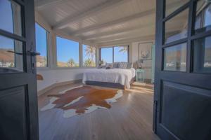 a bedroom with a bed and a large window at The Luxury Penthouse at Casita Palmera in Haría