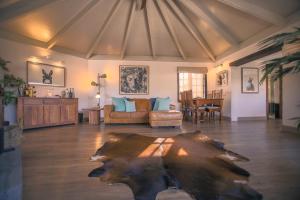 a living room with a table in the middle of a room at The Luxury Penthouse at Casita Palmera in Haría