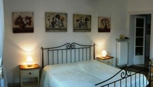 a bedroom with a bed and two tables with lamps at La Castellana in Bergamo