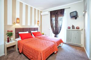 A bed or beds in a room at Anastassiou Hotel - Bike and motorcycle friendly hotel