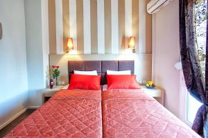A bed or beds in a room at Anastassiou Hotel - Bike and motorcycle friendly hotel