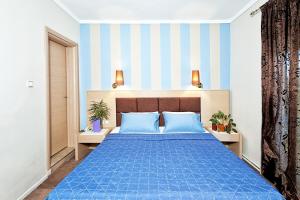 A bed or beds in a room at Anastassiou Hotel - Bike and motorcycle friendly hotel