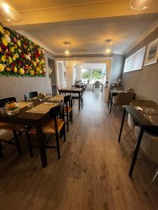 a restaurant dining room with tables and chairs at Orient B&B in Holyhead