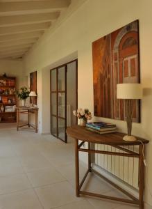 a living room with a table and a painting on the wall at Casa Los Bancales in Candeleda