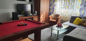 a living room with a red pool table in it at Apartament u Ani in Przeczyce