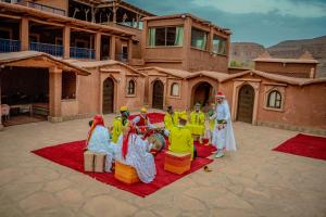 a group of people standing around in front of a building at Ouednoujoum Ecolodge & Spa in Ouarzazate