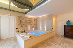 a large bathroom with a tub in a room at Masseria dei Monaci in Otranto