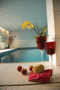 a bathroom with a swimming pool with tomatoes and two wine glasses at Haus Wandl in Seefeld in Tirol