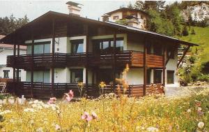 a large wooden house in a field of flowers at Haus Wandl in Seefeld in Tirol