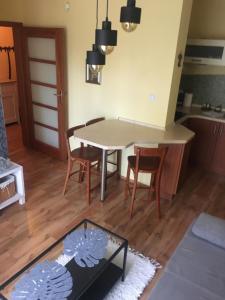a kitchen and dining room with a table and chairs at Apartament M in Polanica-Zdrój