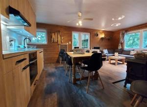 a kitchen and living room with a table and chairs at Chalet Noisette in Durbuy