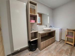 a bathroom with a sink and a counter with a mirror at Chalet Noisette in Durbuy +2 photos