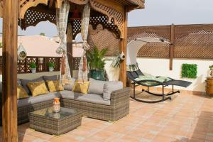 a porch with a couch and a chair at Perlekech Riad & Spa in Marrakech