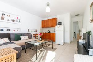 a living room with a couch and a table at Gemini Maspalomas in San Bartolomé +18 photos
