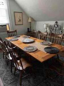 a wooden table with chairs and a dining room at Redefined Alchemy - Bright, eclectic, pretty Apt 3E in Little Falls