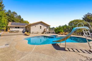 a swimming pool with a slide in a yard at MeadowView on Darby in Sebastopol
