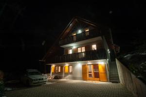 a house at night with a car parked in front of it at Holiday Home Zelenka in Cerklje na Gorenjskem