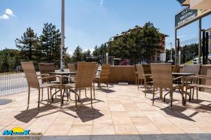 a group of chairs and tables on a patio at Monix Palace Zlatibor in Zlatibor