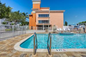 a swimming pool in front of a building at Madeira Bay Resort 509 in St Pete Beach