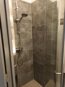 a bathroom with a shower with a glass door at Studio Centre ville Castellane in Castellane