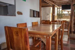 a dining room with a wooden table and chairs at HOTEL Alejandria Barichara in Barichara