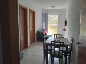 a kitchen and dining room with a table and chairs at Apartamento ao lado da Vila Germânica in Blumenau