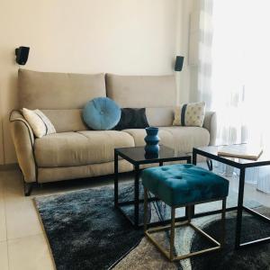 a living room with a couch and two tables at CHARMING APARTMENT NEAR THE BEACH in Villefranche-sur-Mer