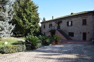 a brick building with a staircase on the side of it at Hotel Il boschetto in Tolentino