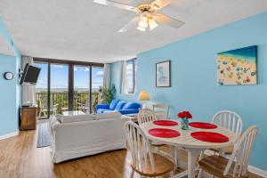 a living room with a table and a couch at Sands Villa 216 in Atlantic Beach