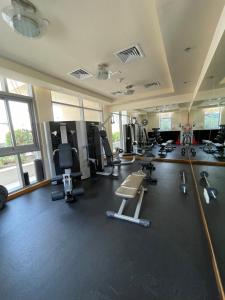 a gym with lots of treadmills and machines at Dubai Marina, Two bedrooms apartment with full Marina View in Dubai
