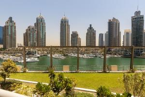a view of a harbor with boats in a city at Dubai Marina, Two bedrooms apartment with full Marina View in Dubai