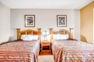 a hotel room with two beds and a lamp at Chula Vista Condo Unit 2647 in Wisconsin Dells