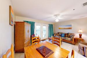 a living room with a table and a couch at Grand Caribbean West 0107 in Perdido Key