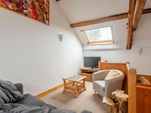sala de estar con sofá y silla en Robins Nest - Uk36208, en Llanfihangel-y-creuddyn