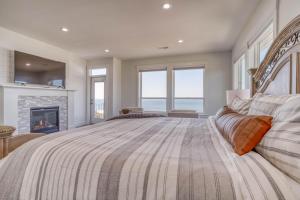 a large bedroom with a bed and a fireplace at Lincoln Landing in Lincoln City +42 photos