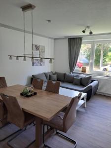 a living room with a table and a couch at Ferienwohnung Carlos 1 und 2 in Bad Harzburg