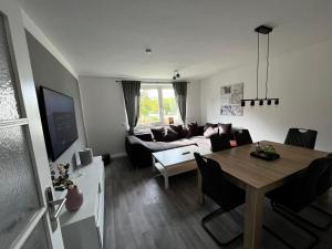 a living room with a table and a couch at Ferienwohnung Carlos 1 und 2 in Bad Harzburg