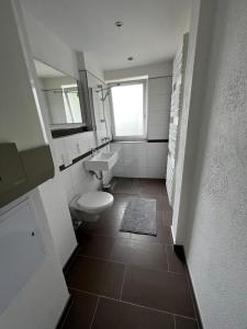 bagno con servizi igienici, lavandino e finestra di Ferienwohnung Carlos 1 und 2 a Bad Harzburg