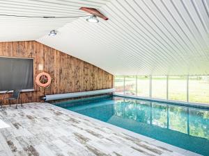 a swimming pool with a flat screen tv in a room with a tv at Stuarts Farm Barn in Westhead