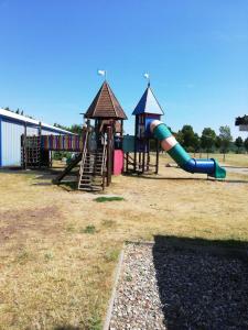 a playground with a slide and a slideintend at Ferienwohnung 313-1-R Stübchen in Neddesitz