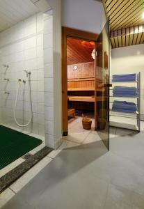 a bathroom with a shower and a glass door at Hotel Simi in Zermatt