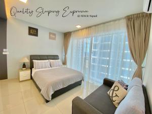 a bedroom with a bed and a couch and a window at Breezy 2-10Pax 2R2B Trefoil Setia City Shah Alam SiS Homestay in Shah Alam
