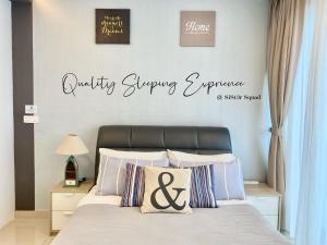 a bedroom with a bed with a sign that readsquality shopping experience at Breezy 2-10Pax 2R2B Trefoil Setia City Shah Alam SiS Homestay in Shah Alam