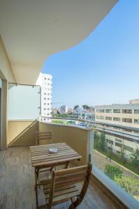 a balcony with a wooden table and chairs and a window at W-Aldorf in Casablanca