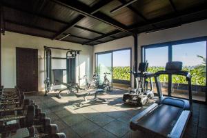 a gym with two treadmills and bikes in a room at W-Aldorf in Casablanca