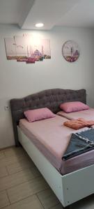 a bed in a room with pink pillows on it at Şirinevler 304 in Istanbul